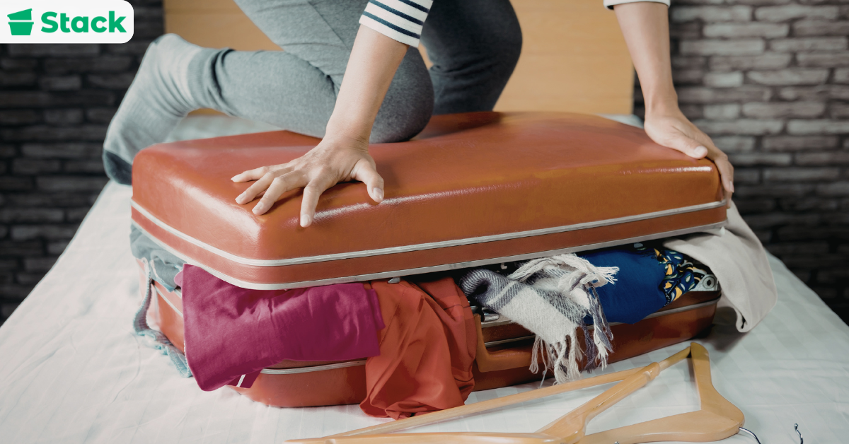 Packing clothes and bedding into moving bags for relocation