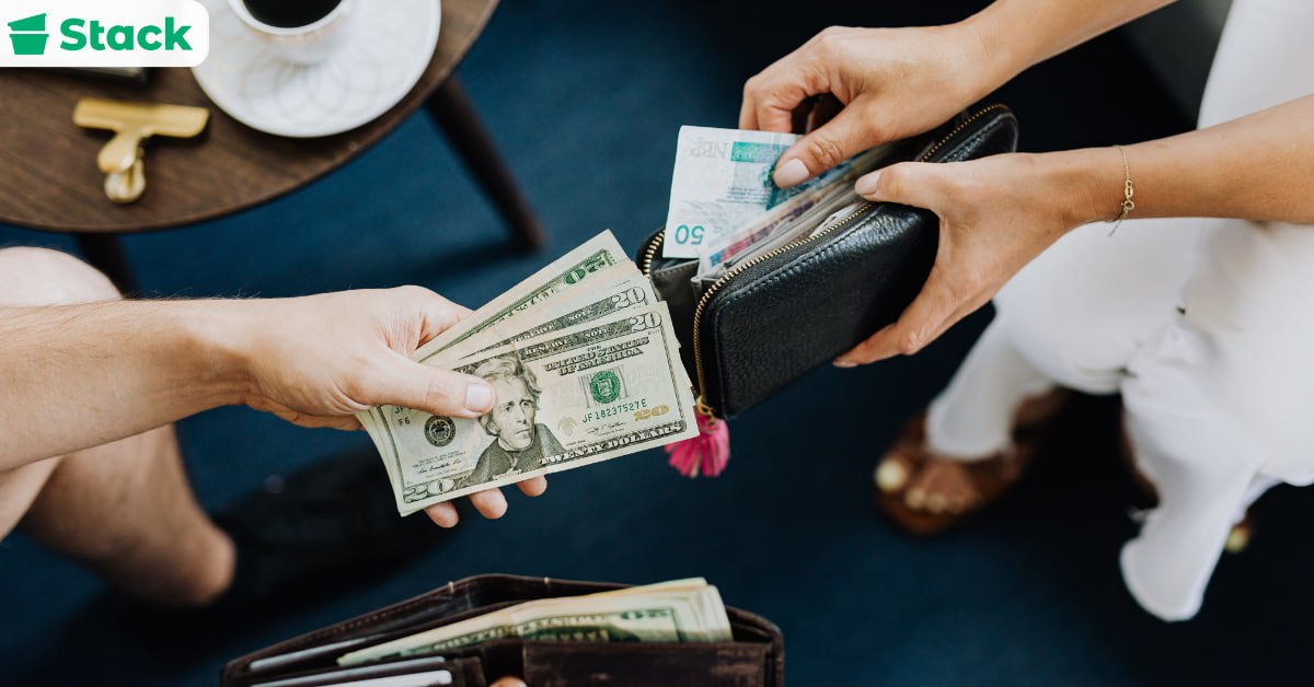 Person taking twenty-dollar bills from a wallet and handing them over as a cash tip