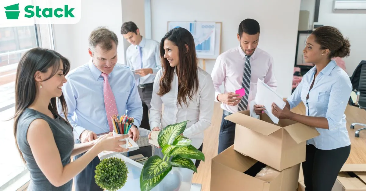 Office employees packing and labeling boxes while organizing supplies during the final 1–2 weeks before moving day.