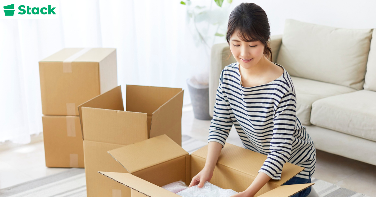 Person organizing boxes showing the best way to pack for moving